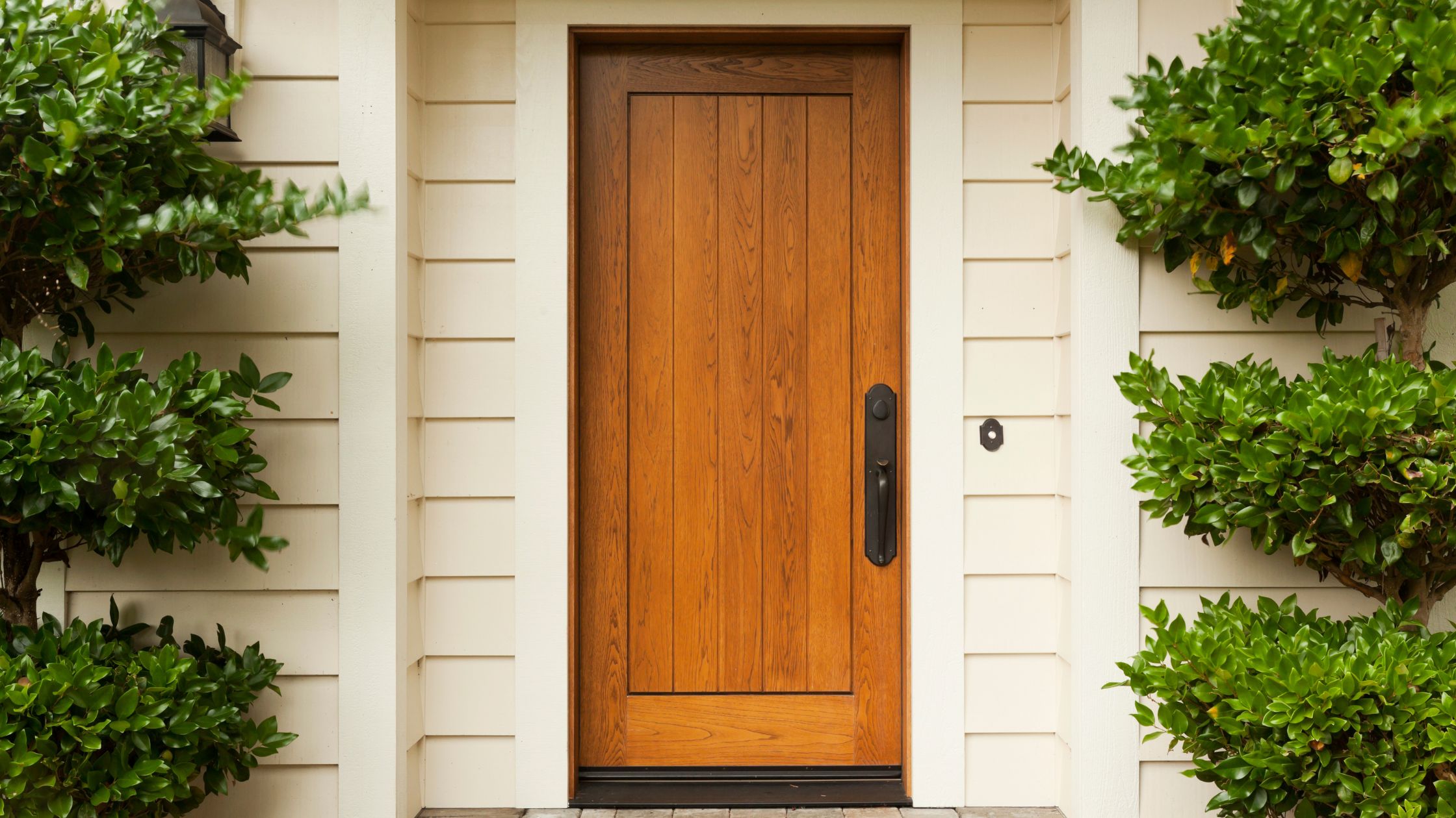 Front entry view showing a traditional wooden door on a home exterior, illustrating the benefits of replacing old wooden doors in Vaughan for better efficiency and curb appeal.