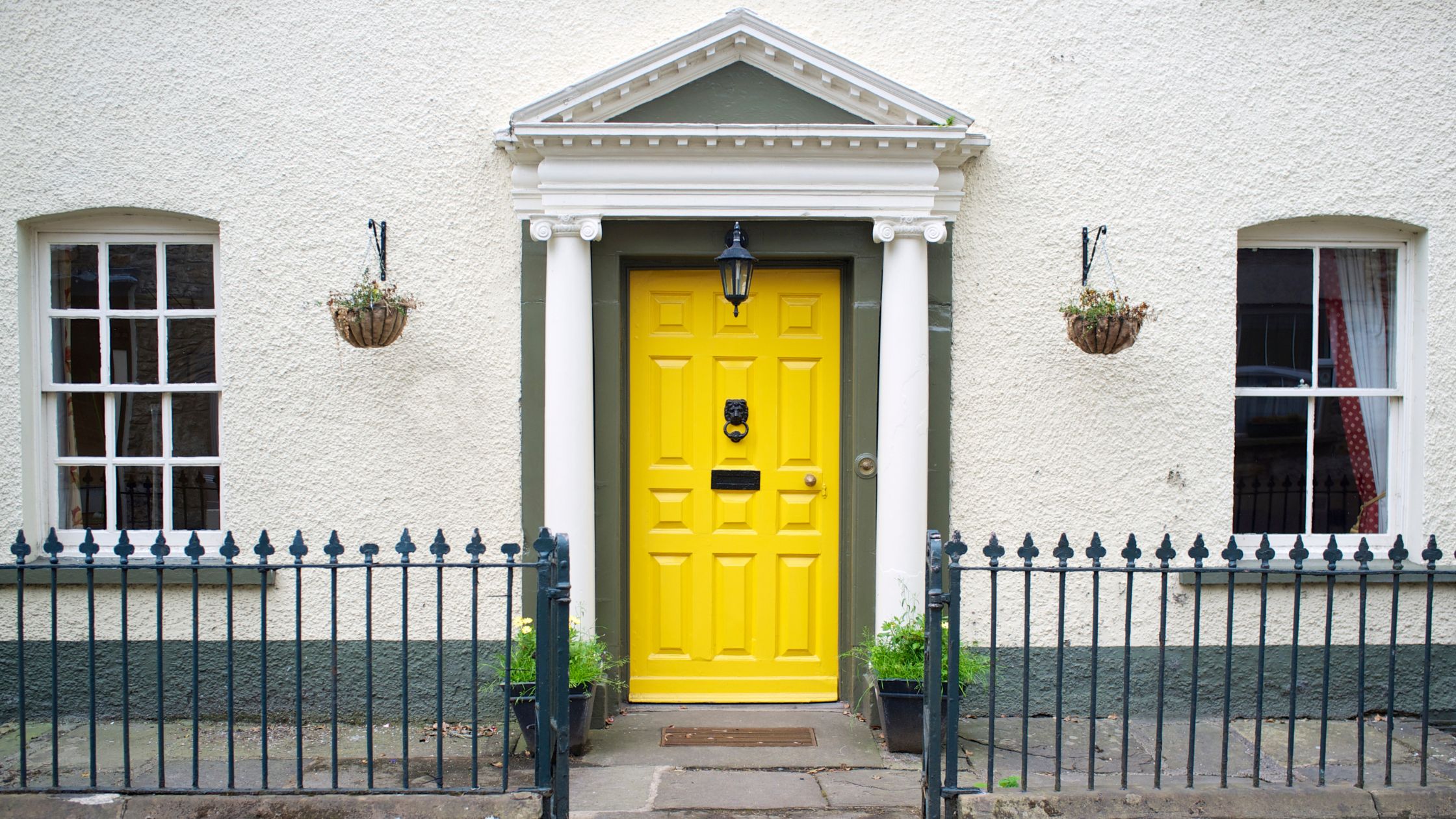 Front view of a house with a solid yellow entry door, representing fire-rated doors in Vaughan for improved safety, compliance, and curb appeal.