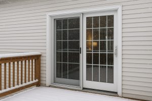 Sliding patio doors with glass grids on a snow-covered deck in a GTA home during winter